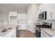 Modern kitchen with granite countertops and stainless steel appliances at 1203 Cypress Shoal Dr., Conway, SC 29526