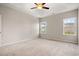 Large main bedroom with neutral carpet, a ceiling fan, and bright windows at 1203 Cypress Shoal Dr., Conway, SC 29526