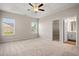 Spacious main bedroom with tray ceiling, ceiling fan, and access to en-suite bathroom and walk-in closet at 1203 Cypress Shoal Dr., Conway, SC 29526