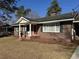 Brick ranch home with covered porch and landscaping at 209 Lewis St., Mullins, SC 29574