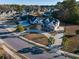 Neighborhood aerial view featuring a well-maintained home with lush greenery, a circular drive, and mature trees at 2207 Wood Stork Dr., Conway, SC 29526