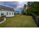 A green, well-maintained backyard is enclosed by a fence for privacy and security at 2207 Wood Stork Dr., Conway, SC 29526