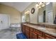 Bathroom featuring double vanity, granite countertops, bathtub, and ample storage at 2207 Wood Stork Dr., Conway, SC 29526