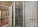 Bathroom with tiled shower stall and glass door with view to bedroom beyond at 2207 Wood Stork Dr., Conway, SC 29526