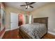 Comfortable bedroom with hardwood floors, ceiling fan, and ensuite bathroom access at 2207 Wood Stork Dr., Conway, SC 29526