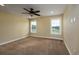 Cozy bedroom with carpeted floor, ceiling fan, and bright natural light from two windows at 2207 Wood Stork Dr., Conway, SC 29526