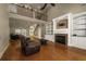 Open concept living room featuring a fireplace, built-in shelves, hardwood floors, and plenty of seating at 2207 Wood Stork Dr., Conway, SC 29526