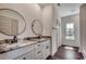 Bathroom with dual sinks, granite countertop, modern faucets, and circular mirrors at 2682 Hugo Rd., Conway, SC 29527