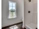 Bright bathroom with a shower and window providing a view of the outdoors at 2682 Hugo Rd., Conway, SC 29527