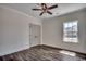 Cozy bedroom featuring hardwood floors, ceiling fan, and a large window at 2682 Hugo Rd., Conway, SC 29527