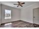 A well-lit bedroom featuring hardwood floors, a ceiling fan, and a large window at 2682 Hugo Rd., Conway, SC 29527