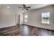 A bright bedroom with hardwood floors, a ceiling fan, and a large window providing lots of light at 2682 Hugo Rd., Conway, SC 29527