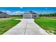 A well-maintained front exterior with a spacious driveway and a two-car garage at 2682 Hugo Rd., Conway, SC 29527