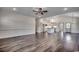 Bright and open living room showcasing wood floors, recessed lighting, and an open layout to kitchen at 2682 Hugo Rd., Conway, SC 29527