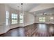 Spacious living room featuring hardwood floors, large windows, and modern lighting at 2682 Hugo Rd., Conway, SC 29527