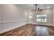 Bright living room features hardwood floors, a ceiling fan, and a view of the front yard at 2686 Hugo Rd., Conway, SC 29527