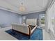 Tranquil bedroom with a decorative chandelier, balcony doors, and a plush area rug at 3788 Waterford Dr., Myrtle Beach, SC 29577