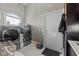 Well-equipped laundry room featuring modern washer and dryer units, bright natural light, and convenient storage solutions at 3788 Waterford Dr., Myrtle Beach, SC 29577
