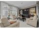 Bright living room with white leather furniture, a dark wood entertainment center, and pool view at 3788 Waterford Dr., Myrtle Beach, SC 29577