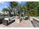 Cozy outdoor seating area with plush cushions and a stone fire pit, set amongst swaying palm trees at 3788 Waterford Dr., Myrtle Beach, SC 29577