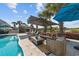Inviting poolside patio with modern outdoor furniture and shade umbrellas, perfect for relaxing by the water at 3788 Waterford Dr., Myrtle Beach, SC 29577