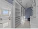 Spacious walk-in closet boasts ample shelving, stylish lighting, and access to a luxurious bathroom with a soaking tub at 3788 Waterford Dr., Myrtle Beach, SC 29577
