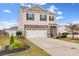 Charming home with a two-car garage, neatly landscaped yard, and a welcoming blue front door at 568 Affinity Dr., Myrtle Beach, SC 29588