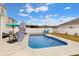 Swimming pool surrounded by a patio with lounge chairs, an umbrella and a dining table at 568 Affinity Dr., Myrtle Beach, SC 29588