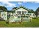 Backyard featuring a deck, green siding, lattice work, and lush green grass at 1305 Conifer Ct., Murrells Inlet, SC 29576