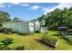 Spacious backyard with a deck, grill, bicycles, and swing seat surrounded by greenery at 1305 Conifer Ct., Murrells Inlet, SC 29576