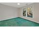 Cozy bedroom featuring a ceiling fan, green carpet, and large window with a backyard view at 1305 Conifer Ct., Murrells Inlet, SC 29576
