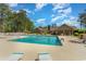 Beautiful community pool surrounded by lounge chairs and lush landscaping at 1305 Conifer Ct., Murrells Inlet, SC 29576