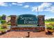 Entrance to Spring Forest community featuring brick sign with lush landscape at 1305 Conifer Ct., Murrells Inlet, SC 29576