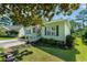 Quaint home with a ramp, green shutters, and an American flag in a landscaped yard at 1305 Conifer Ct., Murrells Inlet, SC 29576