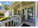 Inviting porch with rocking chairs, green trim, and decorative plants at the front door at 1305 Conifer Ct., Murrells Inlet, SC 29576