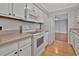 Functional kitchen with white appliances and cabinetry, offering a clean and bright cooking space at 1305 Conifer Ct., Murrells Inlet, SC 29576
