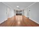 Open living room featuring hardwood floors, neutral paint, and a ceiling fan at 1305 Conifer Ct., Murrells Inlet, SC 29576
