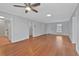 Large living room with hardwood flooring, ceiling fan, and great natural light at 1305 Conifer Ct., Murrells Inlet, SC 29576