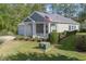 Low angle of the charming gray home displaying manicured landscaping and an American flag at 138 Sugar Loaf Ln., Murrells Inlet, SC 29576