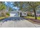 Charming single-story home with a well-manicured lawn and a cozy front porch, with a long drive to the garage at 138 Sugar Loaf Ln., Murrells Inlet, SC 29576