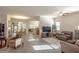 Bright, open-concept living room featuring tile floors, a fireplace, and seamless flow to the dining and kitchen areas at 138 Sugar Loaf Ln., Murrells Inlet, SC 29576