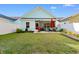 Fenced backyard featuring lush green grass, a patio with an outdoor grill, and a comfortable seating area at 1604 Carsens Ferry Dr., Conway, SC 29526