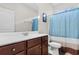 Clean bathroom featuring a vanity with a white countertop, dark wood cabinets, and a bathtub with shower at 1604 Carsens Ferry Dr., Conway, SC 29526