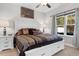 Comfortable bedroom with a large window and a king bed featuring stylish patterned bedding and pillows at 1604 Carsens Ferry Dr., Conway, SC 29526