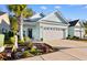Quaint, light blue home with a two-car garage, inviting curb appeal, and a beautifully landscaped front yard at 1604 Carsens Ferry Dr., Conway, SC 29526