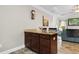 Open-concept kitchen island with granite countertop and wood cabinets, adjacent to a living area at 1604 Carsens Ferry Dr., Conway, SC 29526