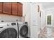 Modern laundry room featuring new front-load washer and dryer and overhead cabinets at 1604 Carsens Ferry Dr., Conway, SC 29526