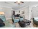 Bright living room features a cozy leather sofa, tray ceilings, and a decorative chess set on the coffee table at 1604 Carsens Ferry Dr., Conway, SC 29526