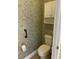 Powder room with a toilet, hand rail, paper holder, and built in cabinet at 323 Sea Turtle Dr., Myrtle Beach, SC 29588