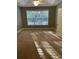 Spacious bedroom featuring a large window, carpet, and a ceiling fan at 323 Sea Turtle Dr., Myrtle Beach, SC 29588